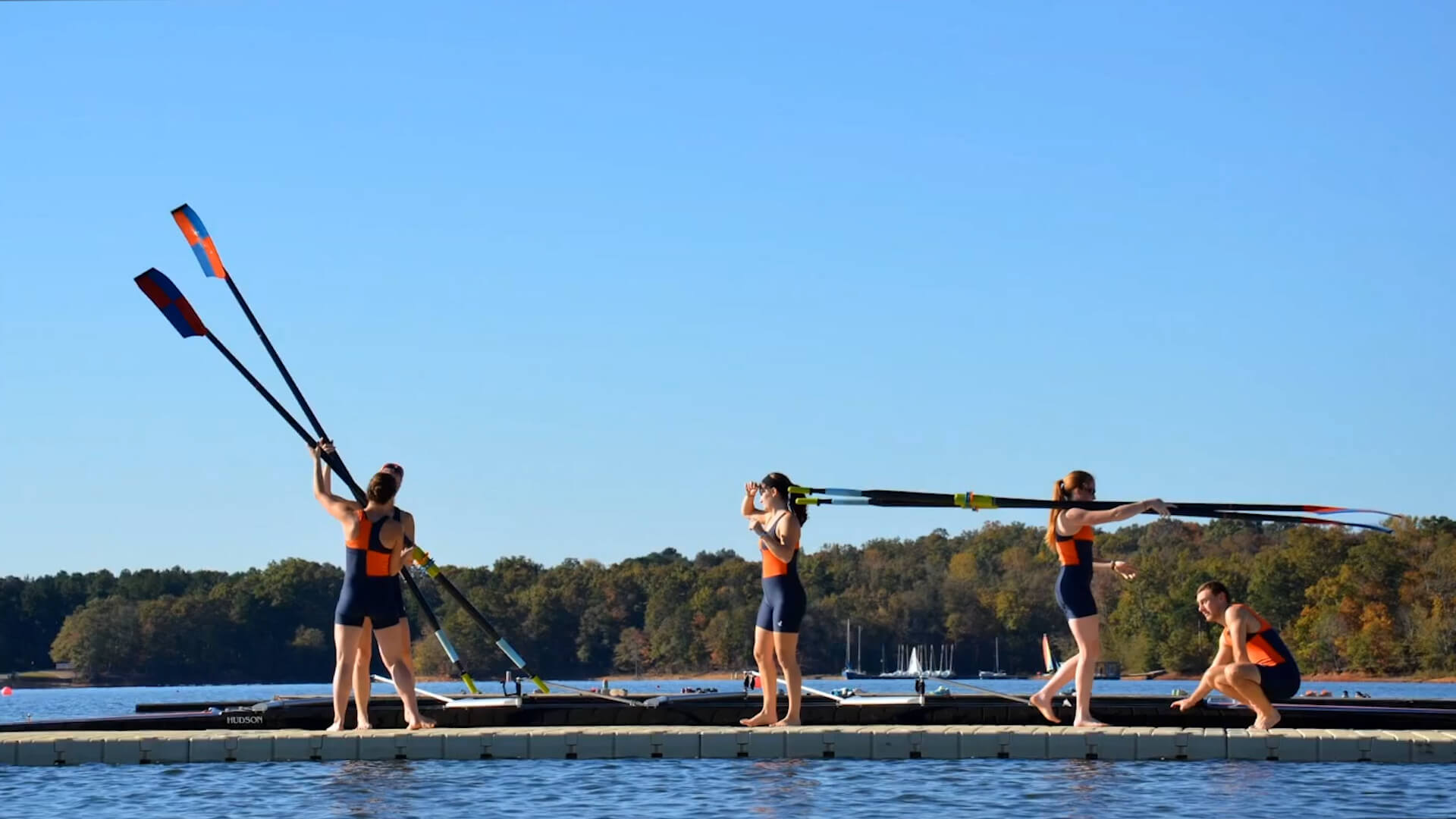 A rowing team is getting prepared to board their boat and launch