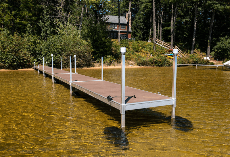 A-simple-I-shaped-rolling-dock-extends-out-into-a-shallow-lake.