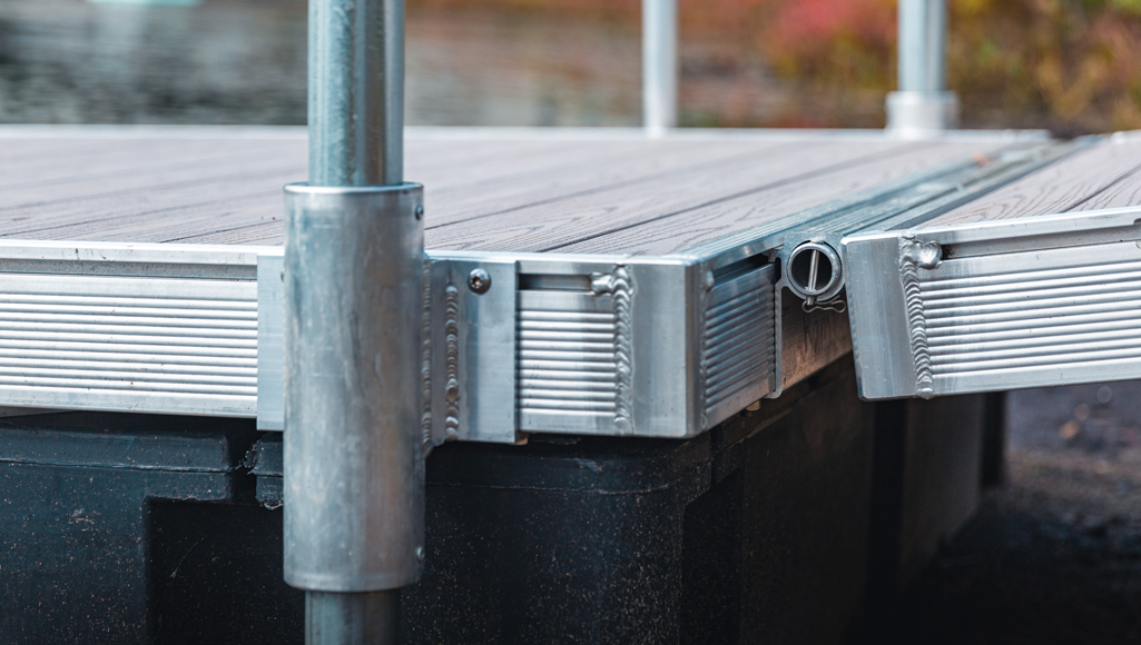 Detail of FWM aluminum floating dock frame extrusion showing custom retention channel for accessories and gangways.