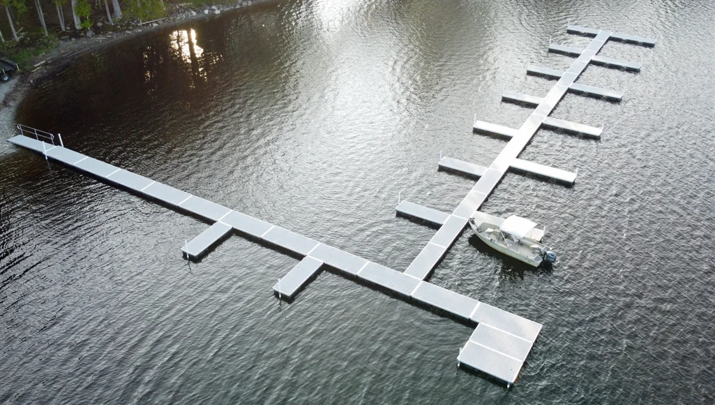 Aerial view of aluminum floating dock marina layout with modular slip sections, designed for commercial waterfront projects.